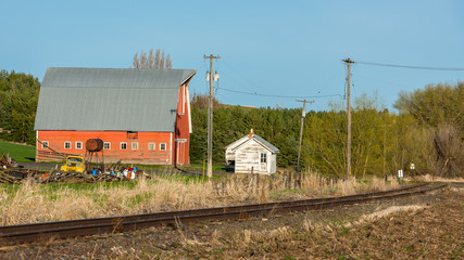 Rustic old barn and rusted train tracks