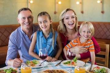 Portrait of cheerful family at restaurant
