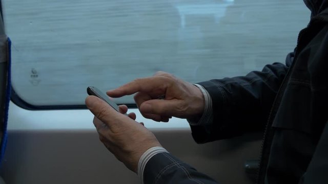 Elderly Man Passenger Travel On Train And Text Messaging On Mobile Phone
