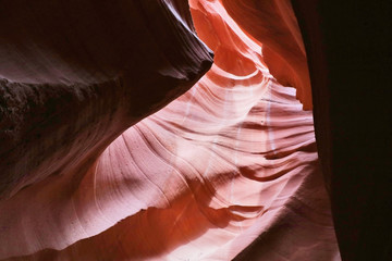 Nature red sandstone textured background. Swirls of old red  sandstone wall abstract pattern in Lower Antelope Canyon, Page, Arizona, USA.