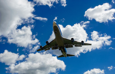 The plane on a background of blue sky and white clouds.