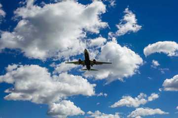 The plane on a background of blue sky and white clouds.