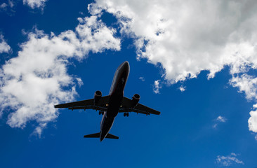 The plane on a background of blue sky and white clouds.