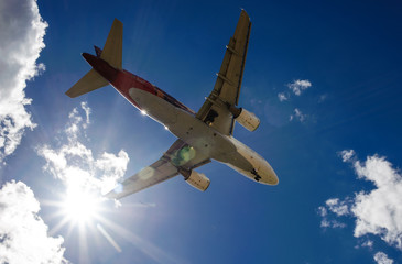 The plane on a background of blue sky and white clouds.