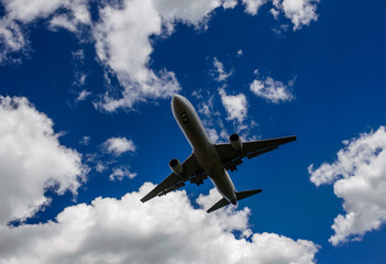 The plane on a background of blue sky and white clouds.