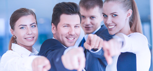 Group of business people pointing to you 