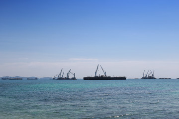 Cargo ship floating in the sea of sriracha city.