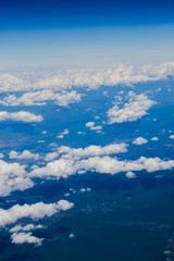 Fototapeta na wymiar Cumulus cloud and field from airplane view