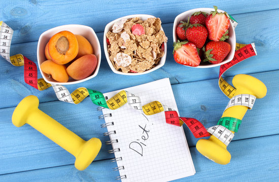 Healthy food, dumbbells, tape measure and notebook with inscription diet