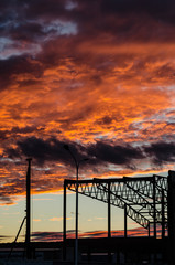 Sinister scarlet sky at sunset, hanging over the factory. Prediction of a catastrophe.