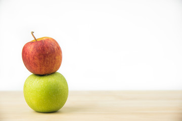 Green apple and red apples on white background.