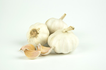 Peeled garlic on a white background.