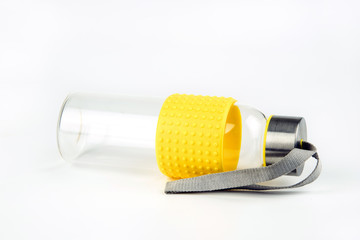 Empty glass water bottle on a white background.