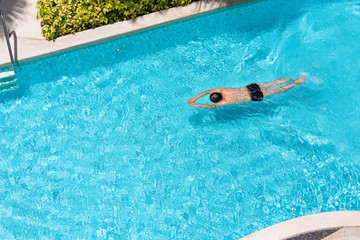 Top view of a man in the swimming pool.
