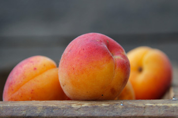 Ripe, sweet apricot on a wooden table. Summer fruit.