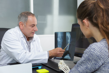 doctor showing xray results to patient