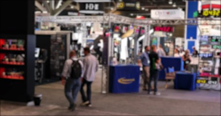 Convention event people and display blurred 4K. Business men and woman walk the floors and interact with trade show sellers in Las Vegas Convention Center. Annual meeting and trade show.