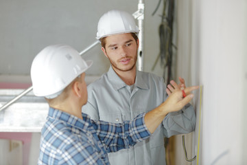 site inspector talking with construction workers