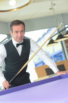 the player in billiards ready to shoot on a ball