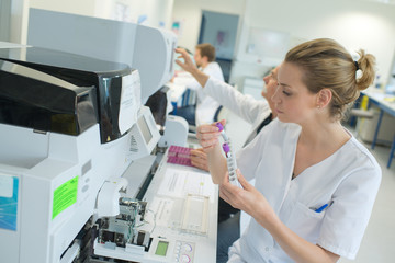 woman scientist working with a device for blood analysis