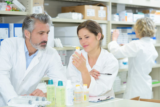 female and male pharmacists in pharmacy