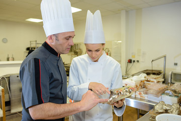 two bakers talking in the kitchen