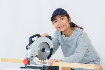 mechanic woman is working with circular saw