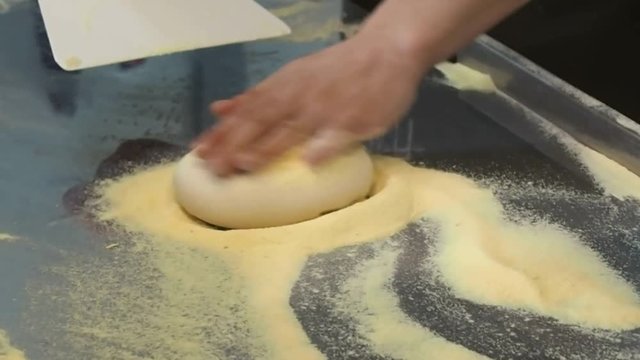 Dough for pizza. The chef prepares a pizza - warm-up and shaping. Concoction of flour and making tortillas. 