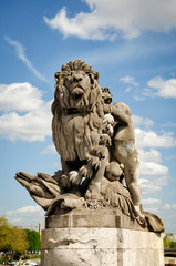 Fototapeta na wymiar The sculpture Lion steered by a child at Alexander III bridge