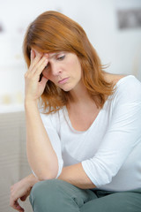 Fototapeta premium crying lonely woman on sofa at home