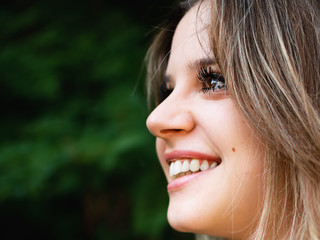 Fototapeta premium Profile of a beautiful smiling girl