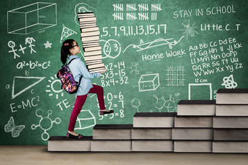 Little girl with textbooks and doodles