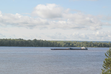 Fototapeta na wymiar Cargo ship sailing on a volga river