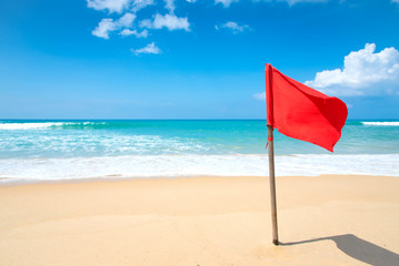 warning sign of a red flag at a beach.