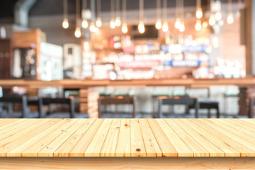 wooden table with blurred cafe background.