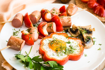 Eggs in peppers, mushrooms and sausage with peppers on skewers
