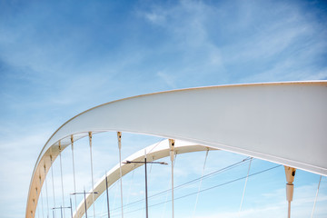 Geometrical view on the modern bridge on the blue sky background