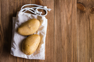 The tubers lie on the canvas on a wooden table