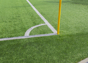 Football field corner with flag, green artificial turf on a stadium, symbol of soccer and other sports