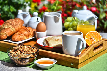 Breakfast served with coffee, juice, croissants and fruits