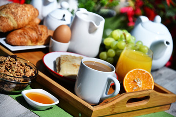 Breakfast served with coffee, juice, croissants and fruits