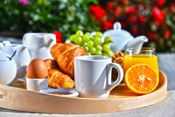 Breakfast served with coffee, juice, croissants and fruits