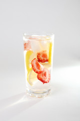 Fototapeta na wymiar Cold cocktail with lemon and strawberries