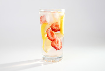 Cold cocktail with lemon and strawberries