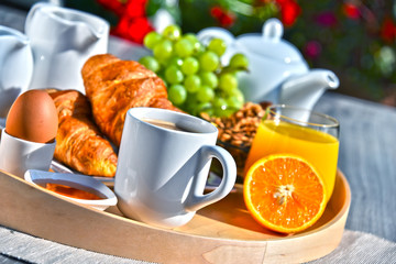 Breakfast served with coffee, juice, croissants and fruits