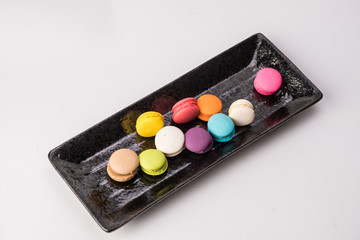  Colorful macaroons   in ceramic black plate.