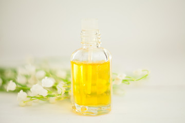 Essence of flowers on table in beautiful glass jar