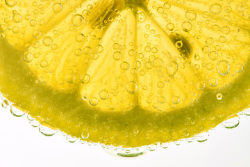 Fototapety  Fresh Lemon Slice In Carbonated Soda Macro Shot