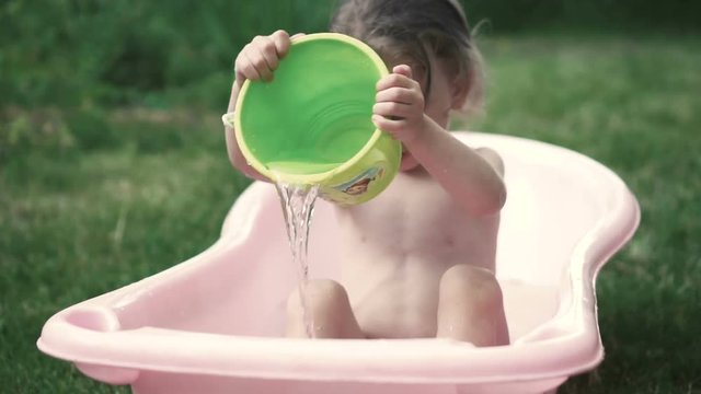 Cute little girl bathing in the bath