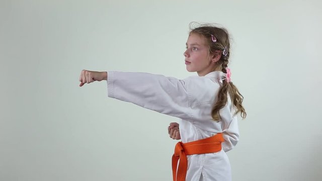 Blows hands trains girl with orange belt